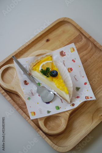Close up shot of mango fruit cake decorate with orange and blueberry