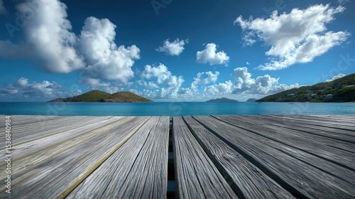 Gray wooden pier overlooking a tranquil island sea.