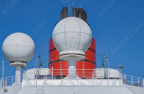 Red and black funnel of classic ocean liner cruise ship cruiseship Elizabeth Victoria against deep blue sky during cruise in summer	