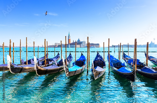 Gondolas on the Grand canal in Venice, Italy. In background, on island of San Giorgio, is the Church of San Giorgio Maggiore with bell tower.