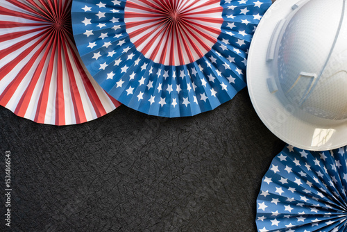 Labor Day holiday theme with red, white and blue paper fans, white hardhat on black background banner with copy space