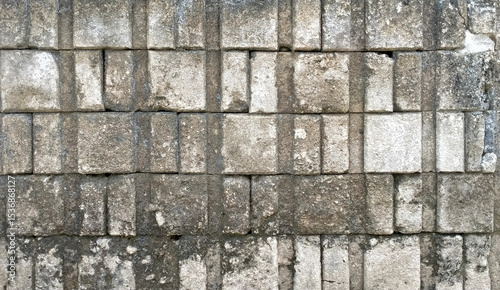 Old brick walls arranged in an orderly manner There are dirt stains on the bricks that have an uneven surface.
