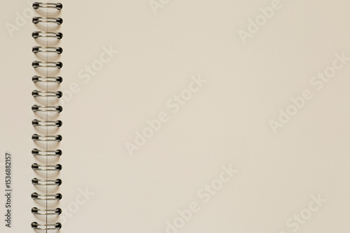close up of blank page of sketchbook with metal spiral binder