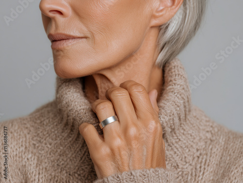 Wellness tracker on hand of mature woman highlighting health metrics and biohacking benefits