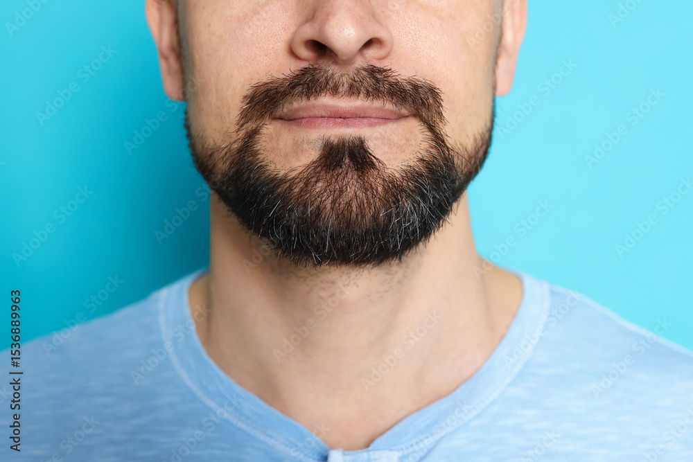 Fototapeta premium Man before shaving on light blue background, closeup