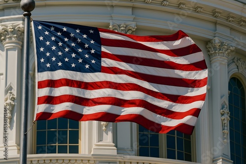 American flag waving in front of historic government building on a sunny day with blue sky