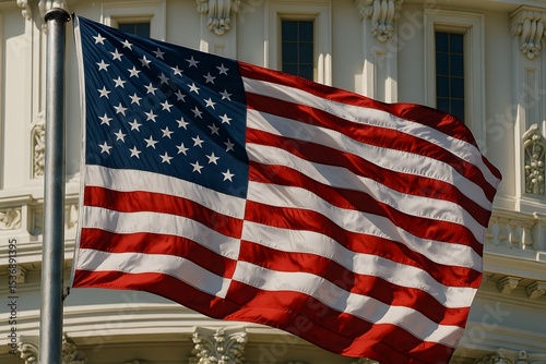 American flag waving in front of historic government building on a sunny day with blue sky