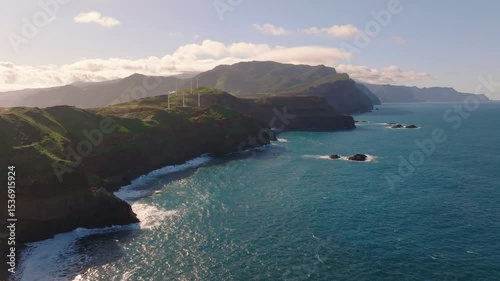 Coastal cliffs of Madeira bathe in sunlight as waves crash against stunning shoreline