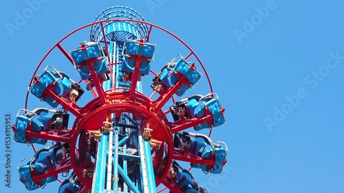 People free falling from tower ride at amusement park. Famous attraction Free Fall Tower in the amusement 