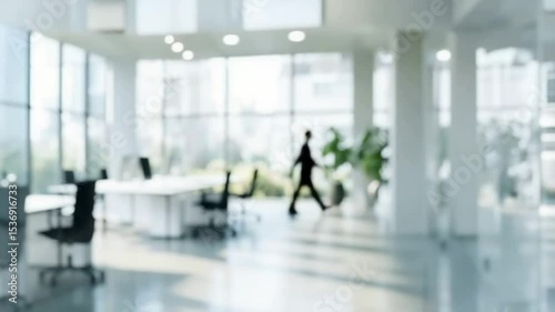 Modern office space with businessman in motion highlighting professional atmosphere. Blurred background footage