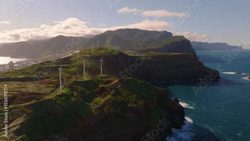 Discover breathtaking cliffs and wind turbines along the stunning coastline of Madeira during a vibrant afternoon