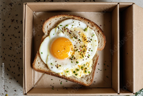 A simple breakfast plate with toasted bread and an egg on top, perfect for a morning meal or snack