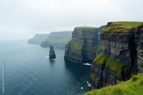 A breathtaking view of the ocean from a cliff, with waves crashing against the shore