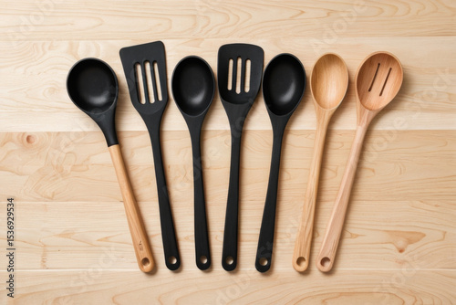 A group of wooden spoons placed on a wooden table, ideal for use in various kitchen settings