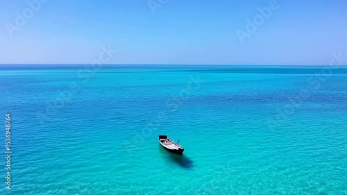 Floating Boat in Turquoise Ocean Water Aerial View