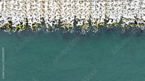 Aerial view of concrete tetrapod. Concrete tetrapods line.  Coastal protection. Wave breakers photo