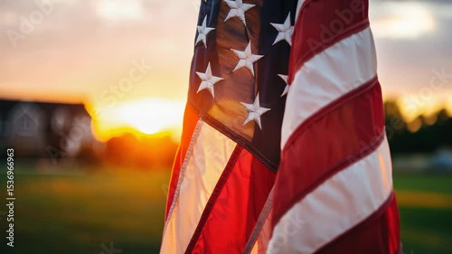 American flag waving gently in the breeze during sunset, with warm golden light illuminating the fabric and creating a serene atmosphere of patriotism and tranquility