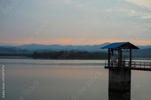 The house of controller for water level in the reservoir with layers of mountains in background