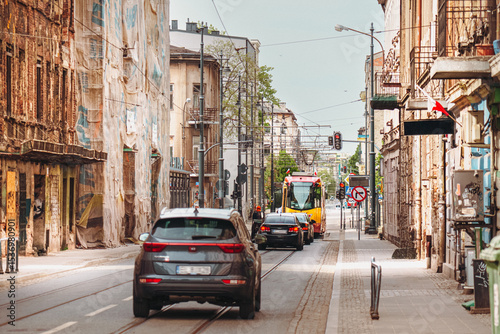 Urban street under renovation with cars and tram in European city