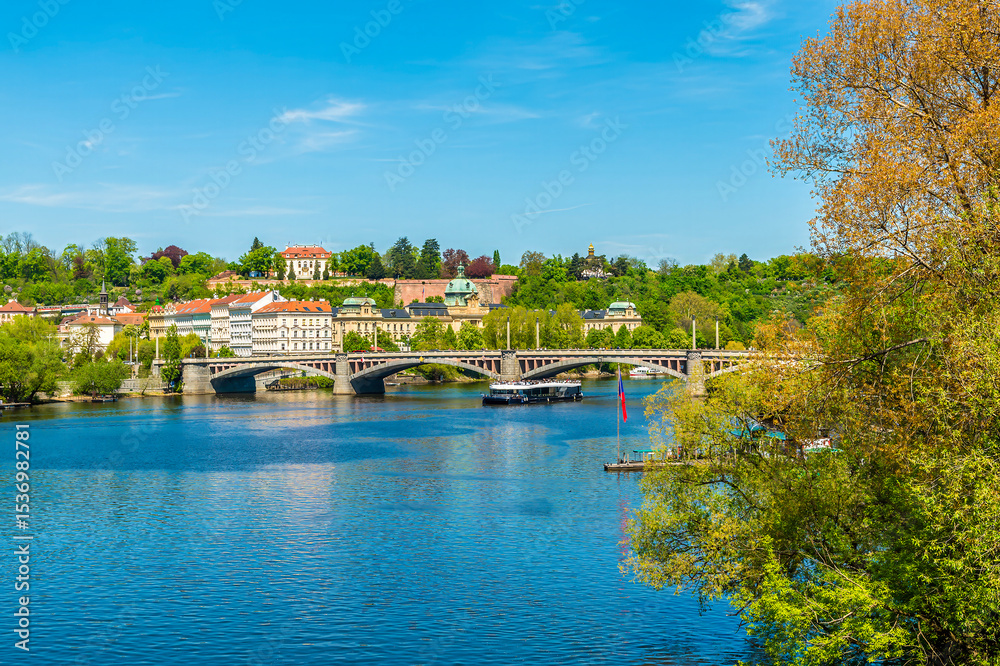 Fototapeta premium A view from the Charles Bridge down the Vltava river towards the Manes Bridge in Prague in springtime