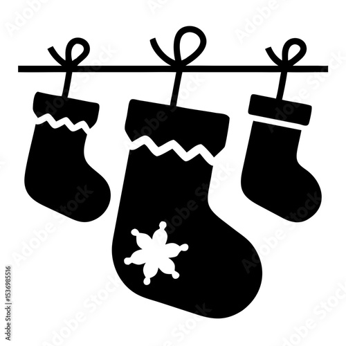 Christmas stockings hanging on clothesline. Festive Christmas socks with snowflake design and ribbon. Perfect Christmas stocking holder for holiday icon design.