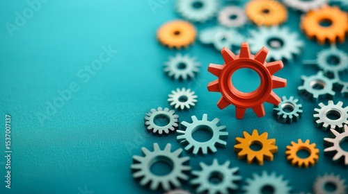 Colorful gears scattered on a blue surface, symbolizing engineering concepts.