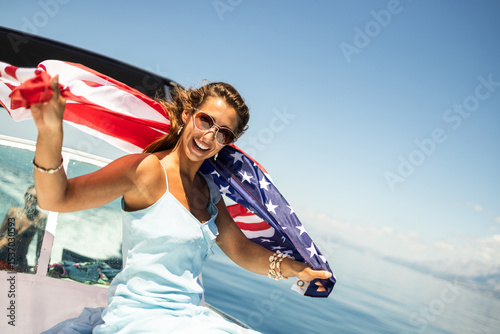 Woman With US National Flag Having Fun  On Private Yacht