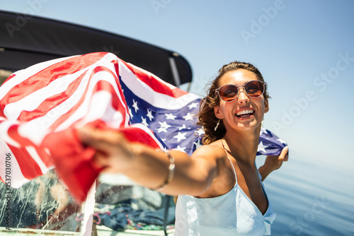Woman With US National Flag Having Fun  On Private Yacht