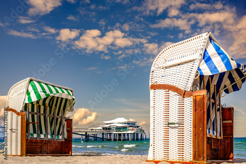 Fototapeta Naklejka Na Ścianę i Meble -  Beachside cabins lined on a sunny day showcasing vibrant colors and clear skies in a coastal location