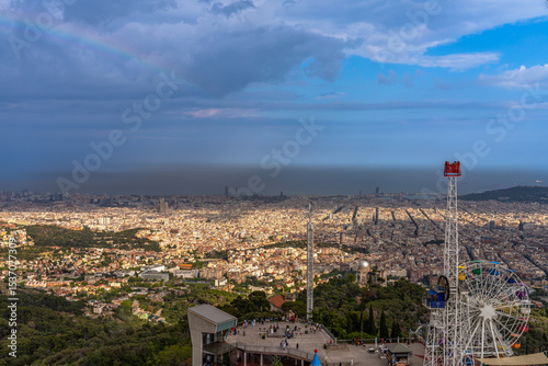 Aerial panorama view of Barcelona city with ferris wheel of the amusement park on top of moutain Tibidabo in summer with blue sky, Barcelona, Catalonia, Spain