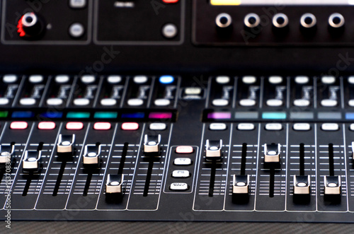 Close up of soundboard faders during a summer music festival show