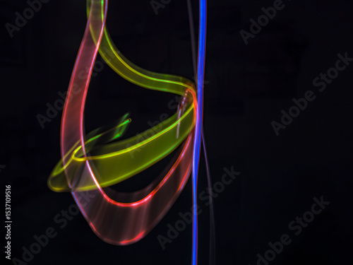 colorful light trails in dark background. Abstract light routes that rotate in vibrant colors. Forestry of the blurry movement of light painting. Blurred lights at night. Intentional camera movement,	