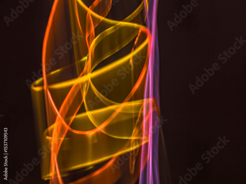 colorful light trails in dark background. Abstract light routes that rotate in vibrant colors. Forestry of the blurry movement of light painting. Blurred lights at night. Intentional camera movement,	