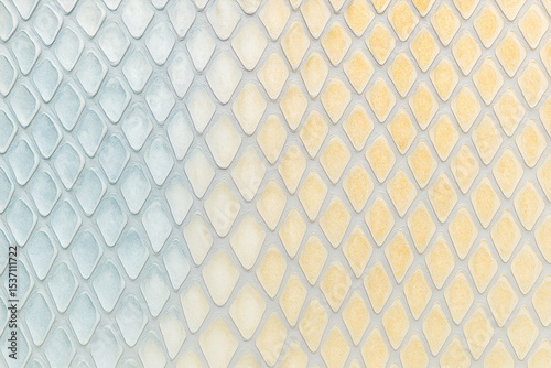 Abstract Pastel Pattern with Raised Diamond Tiles in Blue and Yellow Gradient Colors Forming 3D Geometric Texture Background