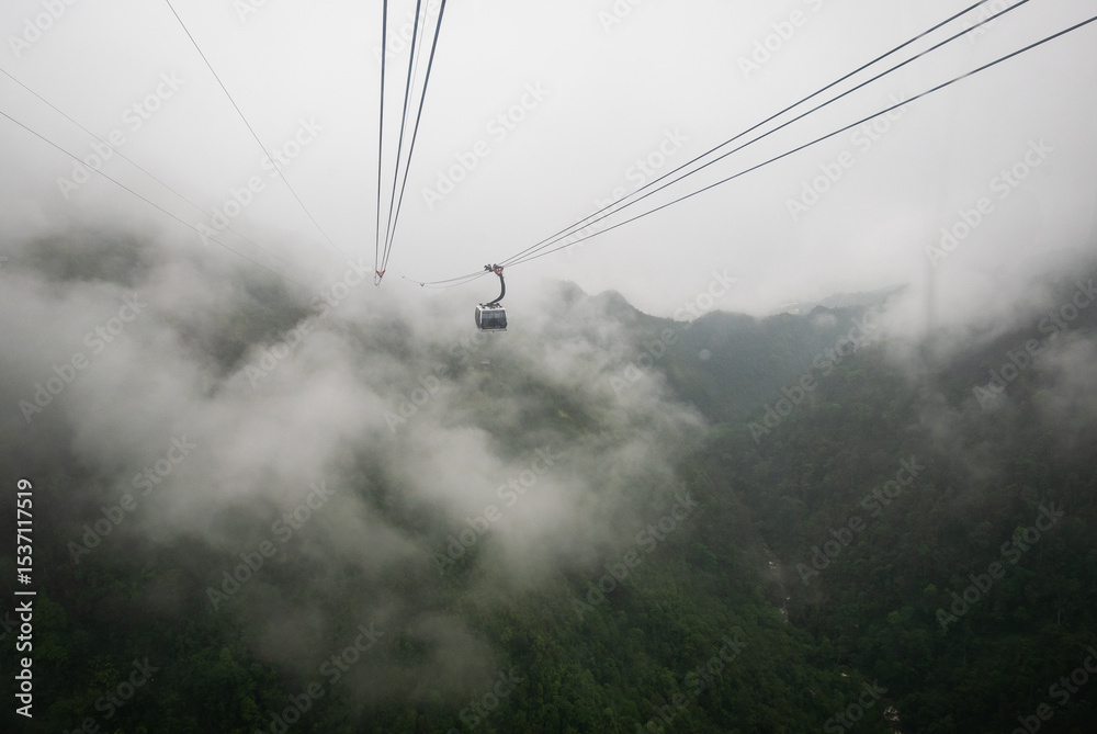 Scenic cable car ride through misty mountains nature adventure cloudy environment aerial view Scenic cable car ride through misty mountains nature adventure cloudy environment aerial view