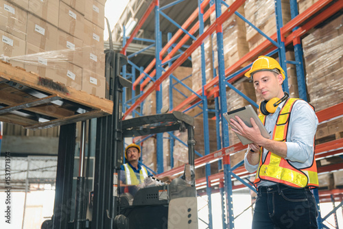 Smart caucasian warehouse man,manager use digital tablet check package with worker forklift driver loading box on shelf, product distribution inventory management, Logistics shipping business planning