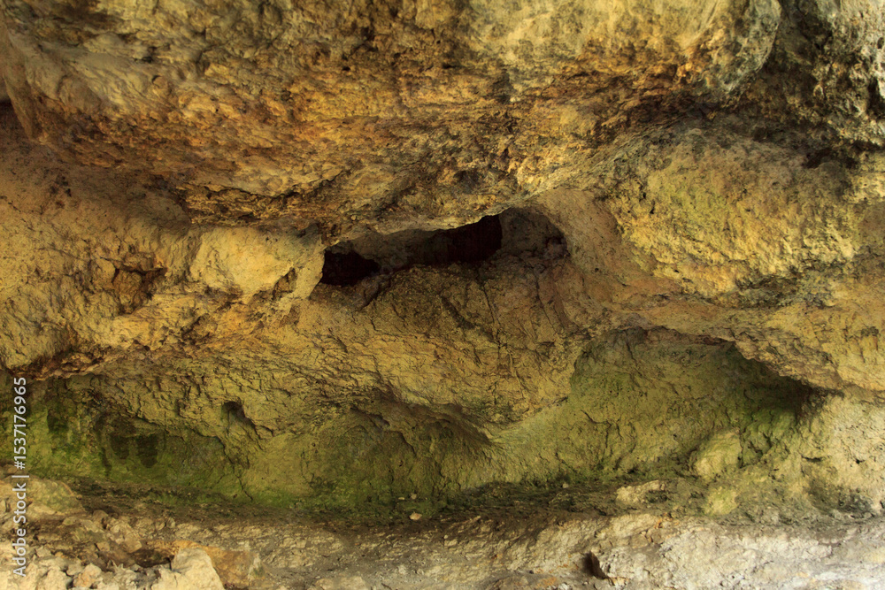 Natural rocky cave interior with textured walls and earthy tones Natural rocky cave interior with textured walls and earthy tones