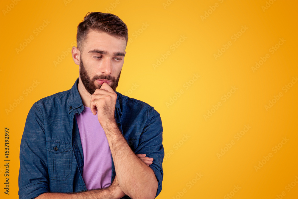 Dreamy young guy thinking over problem, touching his chin on grey studio background. Millennial hipster man making hard choice or decision, imagining something, having doubts Dreamy young guy thinking over problem, touching his chin on grey studio background. Millennial hipster man making hard choice or decision, imagining something, having doubts