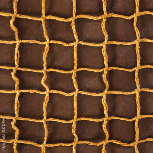 Seamless 4k photo texture material of cloth rope braided net mesh on brown leather surface.