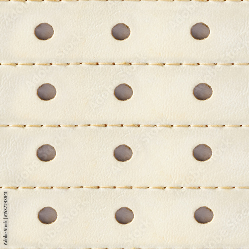 Seamless 4k photo texture material of beige colored leather surface with stitching and holes.