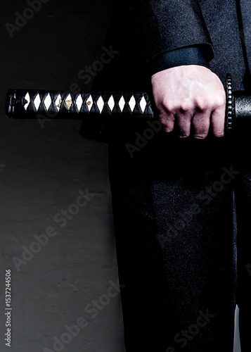 A person holding a samurai sword
