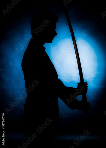 Silhouette of a person holding a samurai sword
