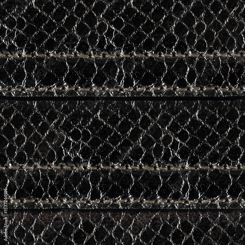 Seamless 4k photo texture material of black colored snake skin leather with stitches.