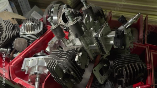 Internal combustion engine parts, cylinders, pistons, cylinder heads are on the shelves in the repair shop