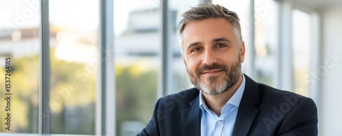 Professional business man portrait with modern office window background