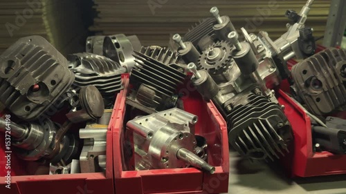 Internal combustion engine parts, cylinders, pistons, cylinder heads are on the shelves in the repair shop