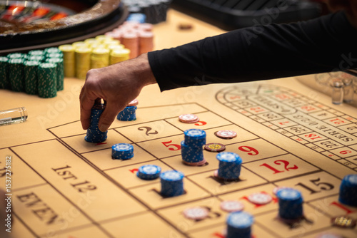 Stacks of blue casino chips on a roulette betting table