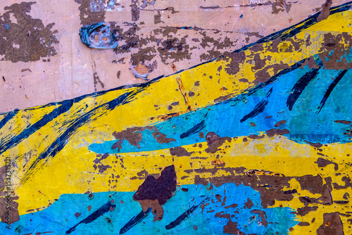 Background with metal in pink, blue and yellow colors, chipped and rusty