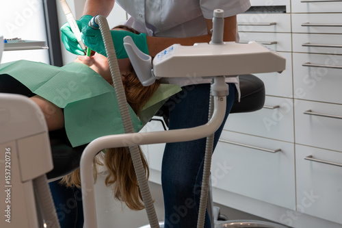 girl recieve tooth treatment in modern dental clinic,Dentist-hygienist conducts a teeth cleaning procedure for a girl in a dental clinic.Removal of tartar.The concept of dentistry,dental treatment