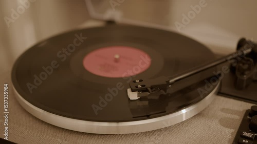 Close-up of a needle playing a vinyl record on a turntable, captured in a realistic photographic style on a fabric-textured surface background